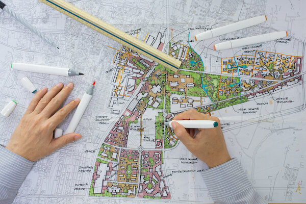 man sketching development plan